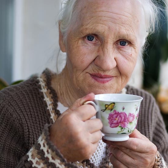 Elderly woman with cup of tea